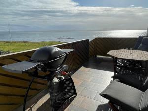 a motorcycle parked on a balcony overlooking the ocean at Ingimarsstaðir in Þórshöfn
