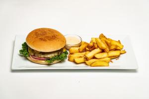 a plate with a hamburger and french fries at Ingimarsstaðir in Þórshöfn +26 photos