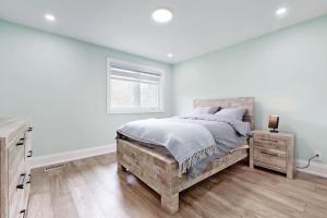a white bedroom with a large bed and a window at Newly renovated luxury villa in Stouffville, ON in Stouffville