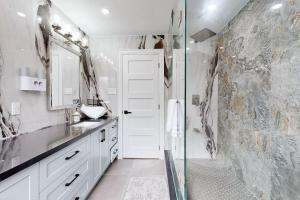 a bathroom with a shower and a sink and a mirror at Newly renovated luxury villa in Stouffville, ON in Stouffville +35 photos