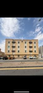 a large building with cars parked in front of it at إستديو هادئ حي حطين قريب من البوليفارد in Riyadh