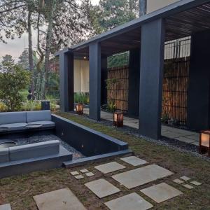 a modern house with a sitting area in a yard at Addostays - Mori Machiya in Bandung