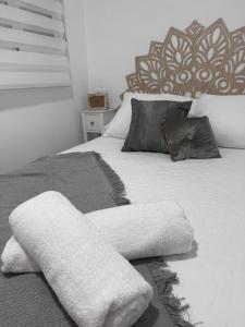 a bedroom with a bed with two towels on it at Olas del Mar in Puerto de Mazarrón