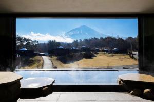a view of a mountain through a large window at The SENSE FUJI in Narusawa