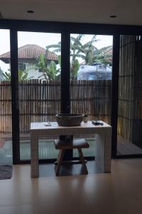 a bathroom with a sink and a bowl on a table at Addostays - Mori Machiya in Bandung +88 photos