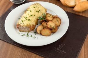 a plate of food with a piece of bread and potatoes at Holiday Inn Montevideo by IHG in Montevideo