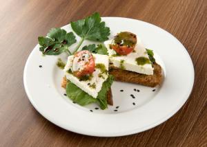 a white plate with a piece of food on a table at Holiday Inn Montevideo by IHG in Montevideo +133 photos