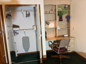 a room with a desk and a chair next to a closet at Red Brick House in Kissimmee