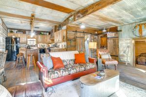 a living room with a couch and a kitchen at half-Mi to Lake Cabin on 43 Acres in Shell Knob! in Shell Knob
