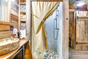 a bathroom with a shower and a sink at half-Mi to Lake Cabin on 43 Acres in Shell Knob! in Shell Knob +31 photos