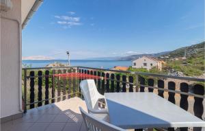 a table and chairs on a balcony with a view of the water at 4 Bedroom Nice Apartment In Sveti Juraj in Sveti Juraj +22 photos