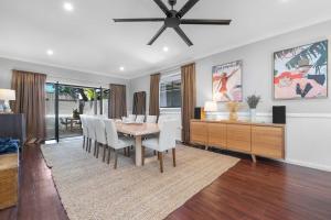 a dining room with a table and chairs and a ceiling fan at Dalton Cottage - Charm & Convenience in Orange