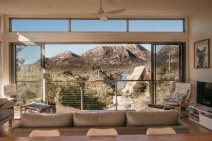 a living room with a large window with a mountain view at The Tides in Coles Bay