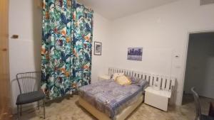 a small bedroom with a bed and a curtain at Matrimoniale francese con bagno privato in Noicattaro