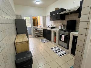 a kitchen with black appliances and a tile floor at Appartement en face de la mer! in Dakar