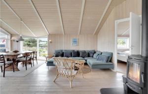 a living room with a couch and a table at Holiday Home Bunken 7 in Ålbæk