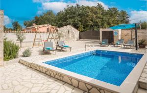 a swimming pool with chairs and a swing and a pool at 2 Bedroom Cozy Home In Visnjan in Rapavel +22 photos