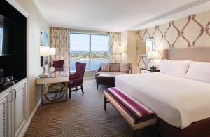 a hotel room with a bed and a large window at Harrah's New Orleans Hotel & Casino - A Caesars Rewards Destination in New Orleans