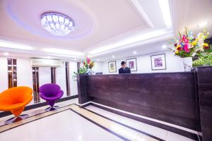 a waiting room with orange and purple chairs at Nascent Gardenia Luxury Suites in Dhaka