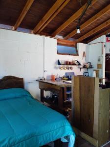 a room with a bed and a wooden desk at CasaEstudio 41 esq 24 in Miramar