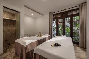 Voodi või voodid majutusasutuse Legacy Hoi An Resort toas