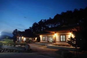 a house with lights on at night at Lee Cho Hanok in Gyeongju +16 photos