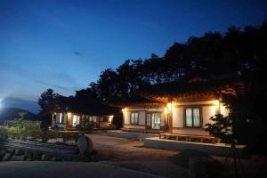 a house with lights on at night at Lee Cho Hanok in Gyeongju