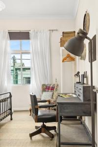 a desk and a chair in a room with a window at 'Enmore Lane' A Central Eclectic Artist Escape in Sydney +16 photos