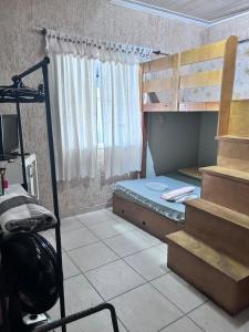 a bedroom with a bunk bed and a staircase at Casa de Praia Itanhaém in Itanhaém