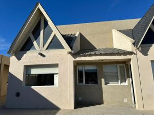 a house with a door in front of it at Kaizen Apart in Caleta Olivia