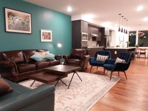 a living room with a couch and chairs and a kitchen at Serene Retreat in Hermitage in Nashville