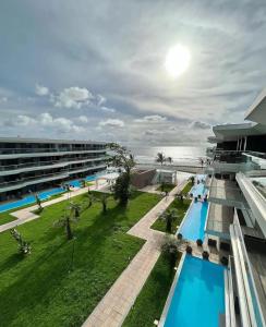 an aerial view of a building with a swimming pool at Exquisite 1-Bedroom at Kololi Sands in Sere Kunda