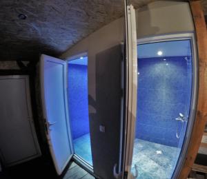 a bathroom with a glass door and a walk in shower at Hikers Hostel in Plovdiv +36 photos