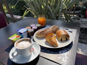 a table with a plate of croissants and a cup of coffee at Chambres d'Hôtes Terra Bella in Lecci +19 photos