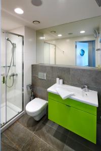 a bathroom with a toilet and a sink and a shower at Hotel Erwin Junker in Holice