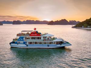 a cruise ship in the water at sunset at Tuần Châu - Phương Đông Motel Hạ Long in Ha Long