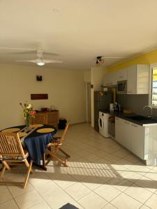 a kitchen and living room with a table and chairs at Sang-Dragon Lodge in Trois-Rivières