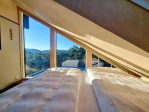 two beds in a room with a large window at Animal trail in Sandnes