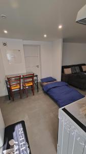 a bedroom with a bed and a table and chairs at Bel appartement F2 entièrement rénové in Sélestat