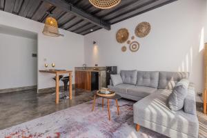 a living room with a couch and a table at Studio Marvel Canggu in Dalung