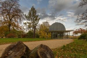 a gazebo with a dome in a park with rocks at Pension Zum-Ratsherrn in Friedrichroda