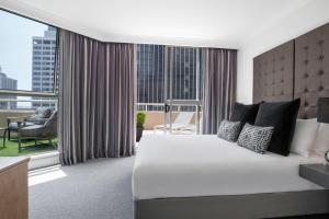 a bedroom with a large bed and a large window at Mantra 2 Bond Street in Sydney +119 photos