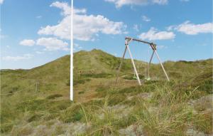 eine alte Schaukel auf einem Hügel mit einer Bank in der Unterkunft Holiday Home Hvide Sande 32 in Havrvig