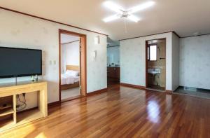 a large living room with a flat screen tv at Jeju Island Love in Jeju