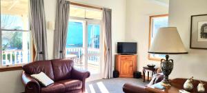 a living room with a chair and a television at City Apartment South Street in Nelson +9 photos