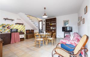 a kitchen and dining room with a table and chairs at 2 Bedroom Amazing Home In Orentano in Orentano