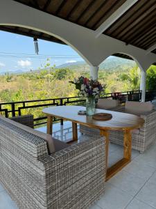 a table and chairs on a patio with a view at Villa Jambu, lovina-kayuputih in Lovina