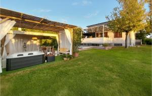 a backyard with a hot tub in the grass at 1 Bedroom Cozy Apartment In Massarosa in Massarosa +16 photos