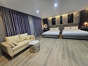 a living room with two beds and a couch at ABC HOTEL BÌNH TÂN in Ho Chi Minh City