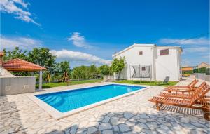 a swimming pool with chairs and a playground at Five-Bedroom Holiday Home In Blato Na Cetini in Blato na Cetini